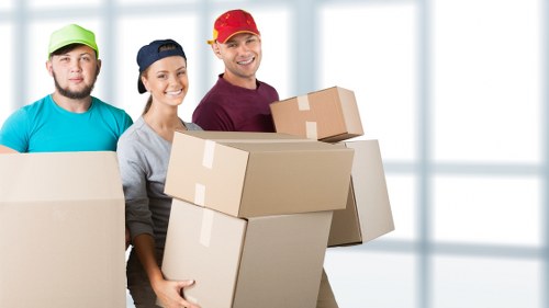 Professional movers using protective gear during a removal van service