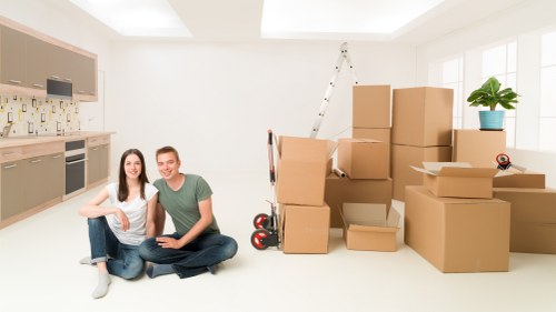 Professional office movers handling furniture and equipment in a central London building