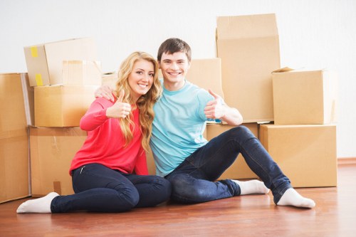 Local movers carrying student items through a Belgravia property
