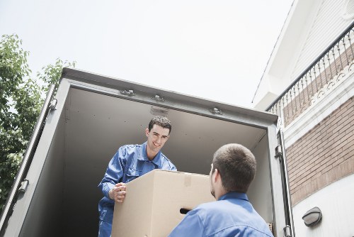 A trained removals team moving a piano through a Belgravia property